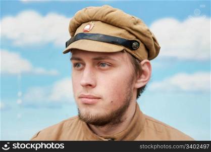 Portrait of soldier in uniform of World War 1 on the background of blue sky. Costume accord the times of World War I. Photo made at cinema city Cinevilla in Latvia. Cockade on the hat do not contain trade mark.