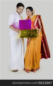 Portrait of South Indian couple with gifts