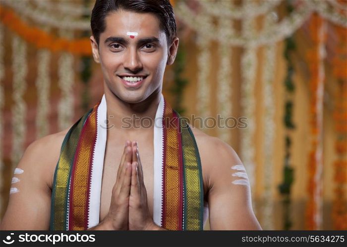 Portrait of South Indian groom greeting