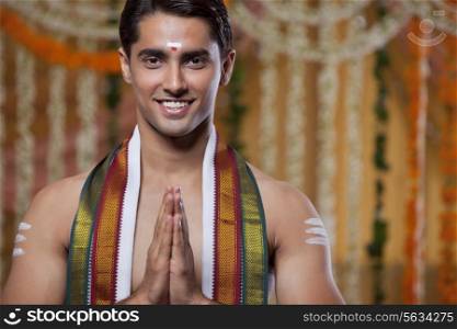 Portrait of South Indian groom greeting