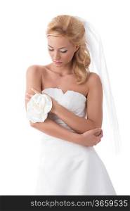 portrait of splendid sensual bride with blonde hair, elegant wedding dress and floral decoration on hand