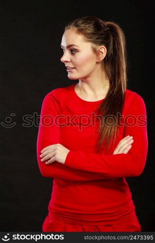 Portrait of sporty fit fitness woman. Attractive young girl thinking in studio on black.