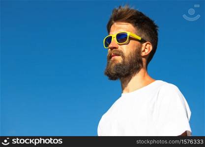 Portrait of sporty man with beard and yellow glasses.