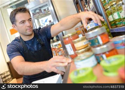 portrait of strapping young seller at shop