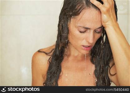 Portrait of stressed young woman in shower