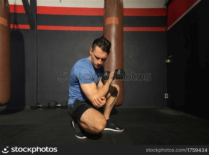 Portrait of strong caucasian man posing muscles in boxing sport club workout at training gym fitness center. Exercise indoor sport equipment. People lifestyle.