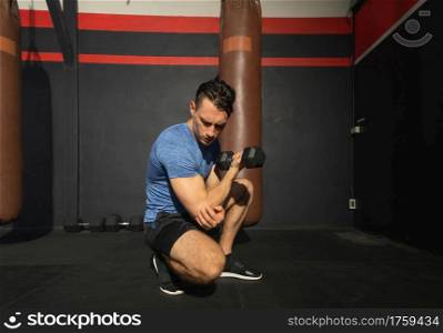 Portrait of strong caucasian man posing muscles in boxing sport club workout at training gym fitness center. Exercise indoor sport equipment. People lifestyle.