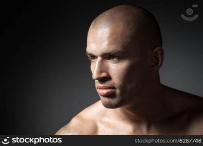 portrait of strong man isolated on dark background