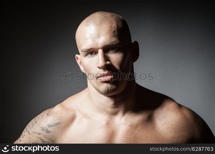 portrait of strong man isolated on dark background