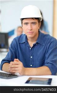 Portrait of student architect with security helmet on