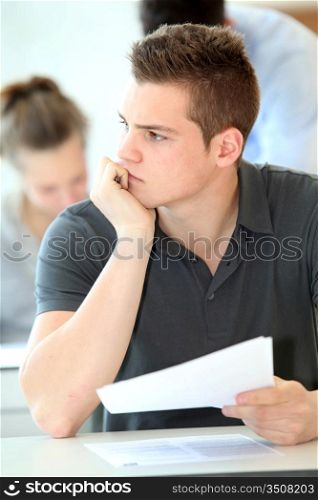Portrait of student boy doing written exam