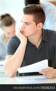 Portrait of student boy doing written exam