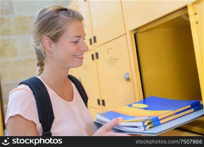 portrait of student opening her locker