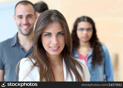 Portrait of student standing in front of group