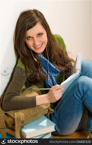 Portrait of student teenager woman with piles of books