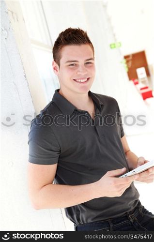 Portrait of student using electronic tablet at school