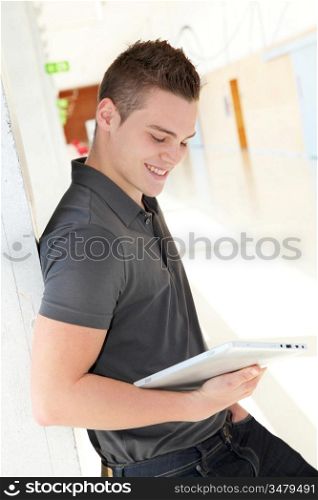 Portrait of student using electronic tablet at school