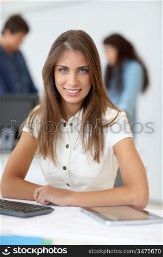 Portrait of student using electronic tablet in class