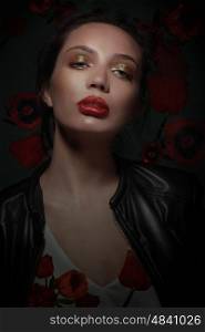 Portrait of stylish woman with poppies flowers. Professional makeup, green eyeshadow and red lips. Fashion.