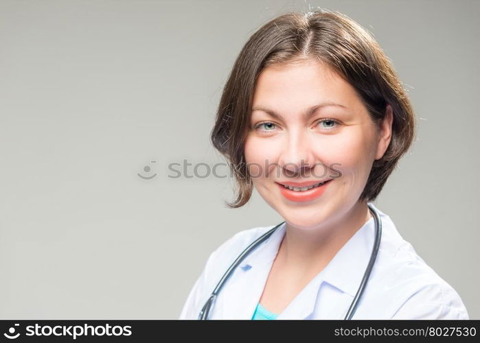 Portrait of successful brunette doctor on a white background