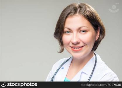 Portrait of successful brunette doctor on a white background