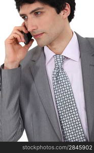 Portrait of successful businessman making telephone call