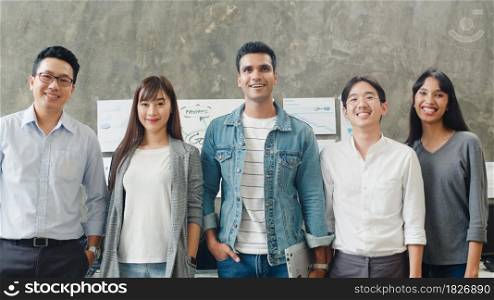 Portrait of successful creative businessman and businesswoman smart casual wear looking at camera and smiling in modern office workplace. Diverse Asia male and female standing together at startup.