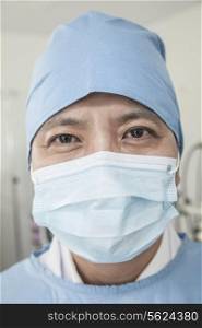 Portrait of surgeon with surgical mask and surgical cap in the operating room
