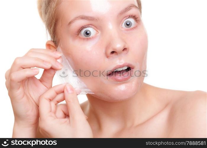 Portrait of surprised girl shocked young woman in facial peel off mask isolated on white. Peeling. Beauty and body skin care. Studio shot.