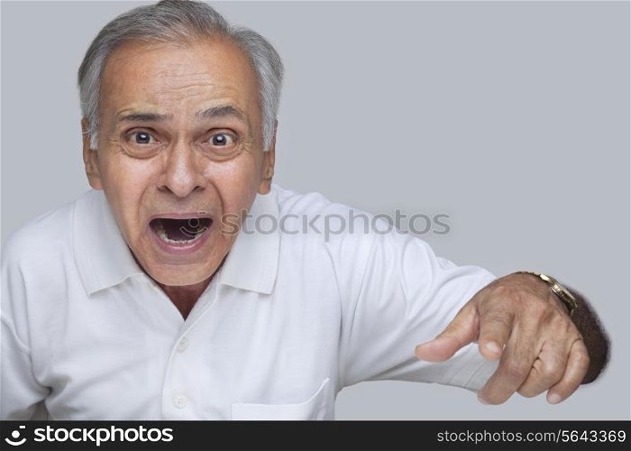 Portrait of surprised man pointing