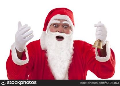 Portrait of surprised Santa Claus with bell over white background