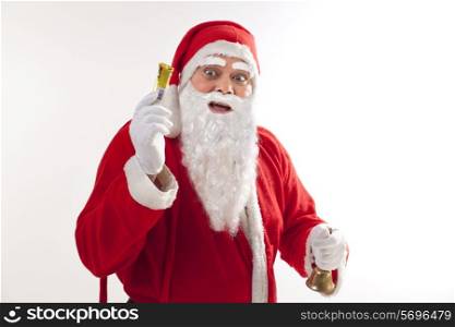 Portrait of surprised Santa Claus with chocolate and bell