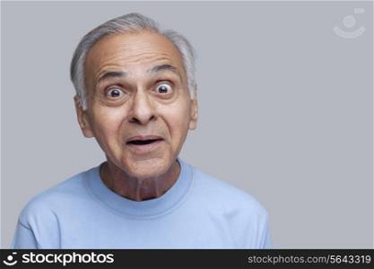 Portrait of surprised senior man raising eyebrows