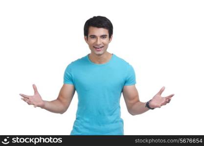 Portrait of surprised young man gesturing over white background