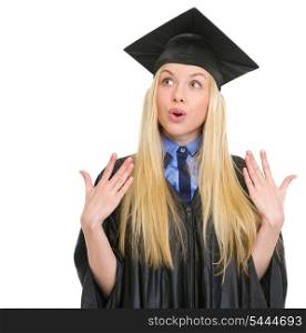 Portrait of surprised young woman in graduation gown