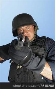 Portrait of Swat officer aiming gun