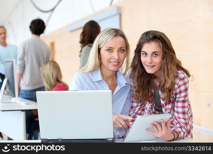 Portrait of teacher and teenage girl in computing class
