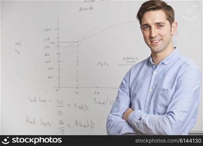 Portrait Of Teacher Standing In Front Of Whitebaord