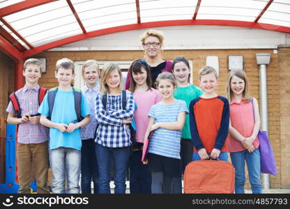 Portrait Of Teacher With Pupils In Playground