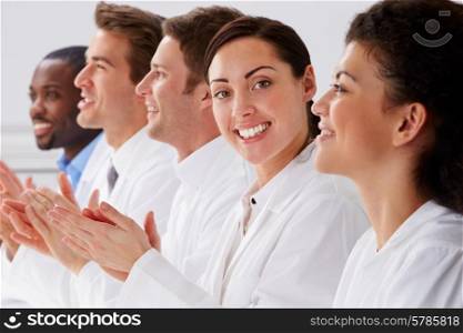 Portrait Of Technician And Colleagues In Laboratory Clapping