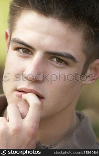Portrait Of Teenage Boy Biting Nails