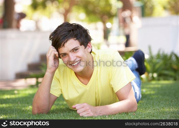 Portrait Of Teenage Boy Laying In Park