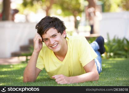 Portrait Of Teenage Boy Laying In Park