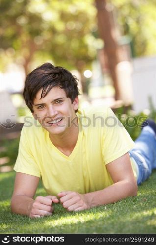 Portrait Of Teenage Boy Laying In Park