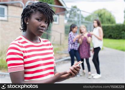 Portrait Of Teenage Girl Being Bullied By Text Message