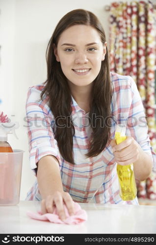 Portrait Of Teenage Girl Helping With Cleaning At Home