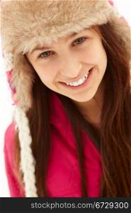 Portrait Of Teenage Girl In Snow Wearing Fur Hat