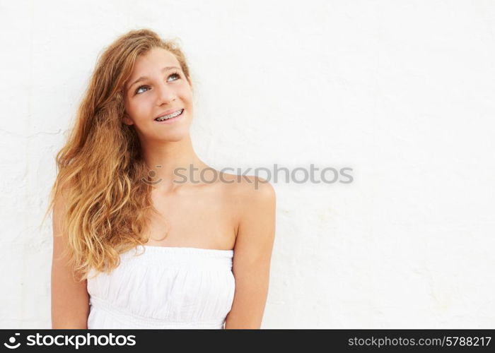 Portrait Of Teenage Girl Leaning Against Wall