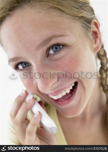 Portrait Of Teenage Girl Smiling And Talking On Cellphone