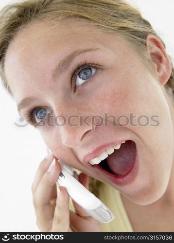 Portrait Of Teenage Girl Smiling And Talking On Cellphone